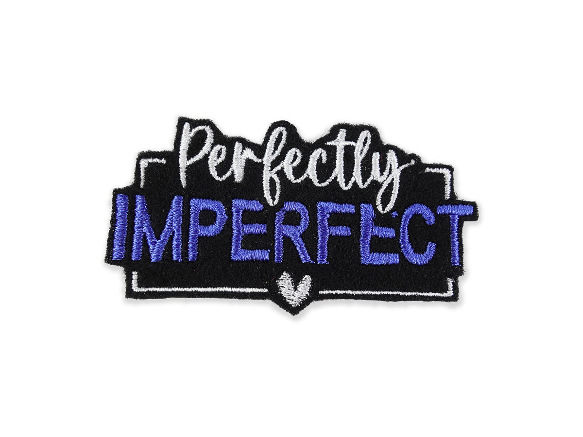 Embroidered "Perfectly Imperfect" patch featuring vibrant blue lettering on a solid black background, finished with a crisp white border and small heart detail.
