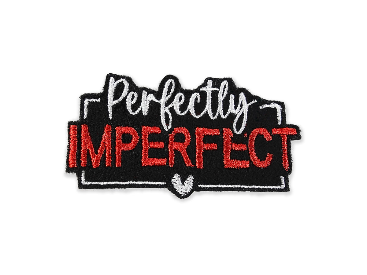 Red and black "Perfectly Imperfect" embroidered patch featuring a black background, white script for "Perfectly," and bold red block letters for "IMPERFECT" with a small white heart detail.