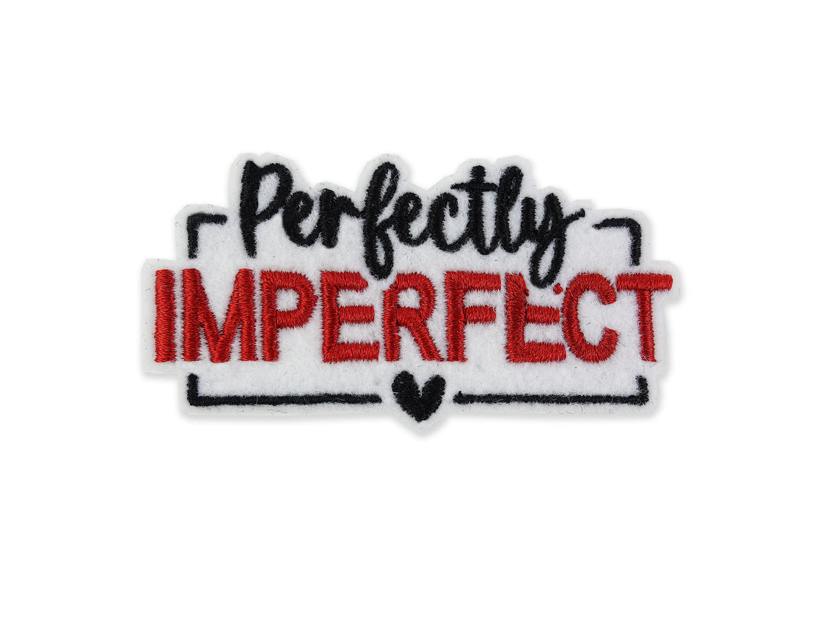 Embroidered "Perfectly Imperfect" patch featuring a white background with bold red block lettering for "IMPERFECT" and black script for "Perfectly," finished with a black heart detail.