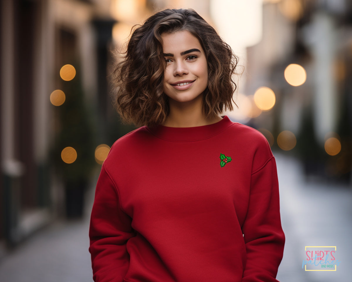 Embroidered holly Christmas patch ironed onto a sweatshirt
