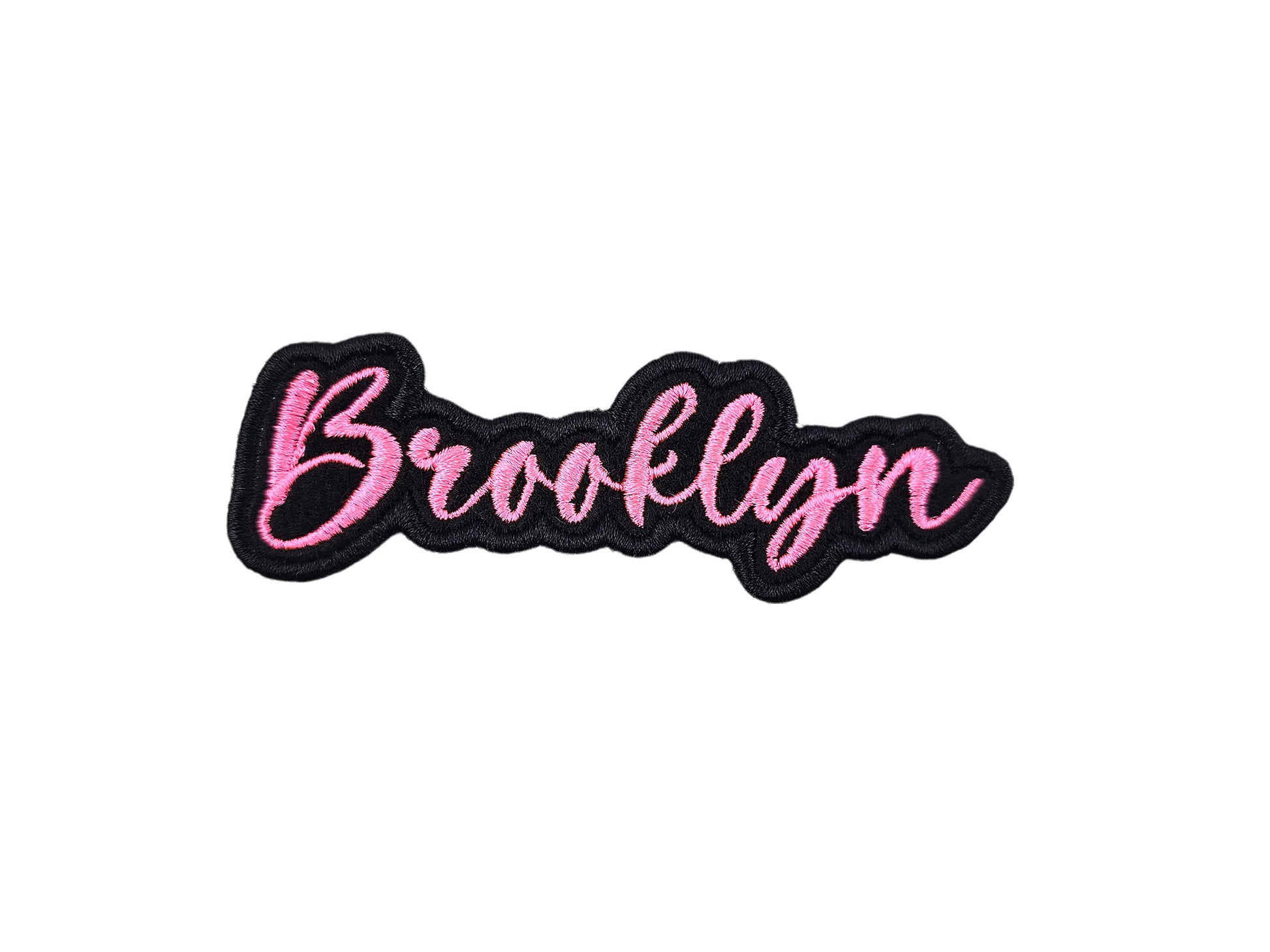 Brooklyn custom name patch by Shirts Patches And More, embroidered in pink script with a black border on a white background.