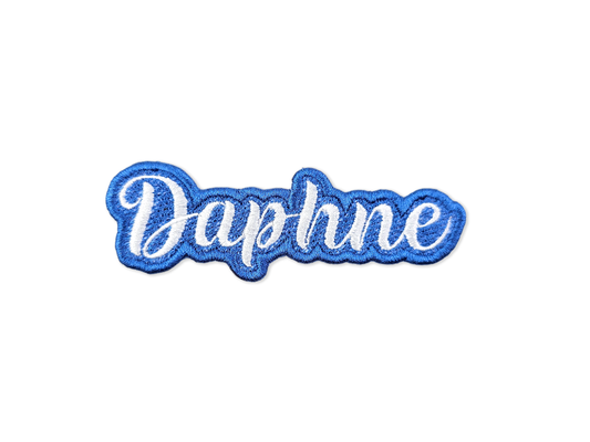 Blue embroidered patch with the name 'Daphne' in white script lettering on a white background