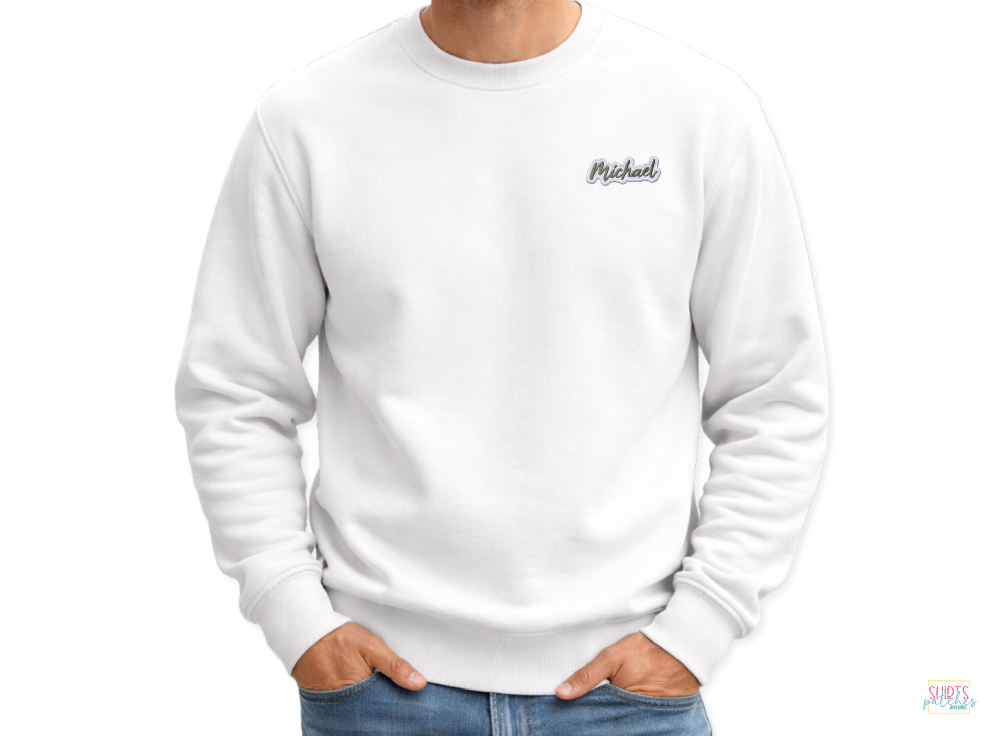 A person wearing a white sweatshirt featuring a custom 'Michael' embroidered name patch with a dark script font and white border on the upper chest.