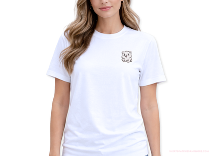 Woman wearing a white t-shirt with a small white Pomeranian patch on the chest against a white background