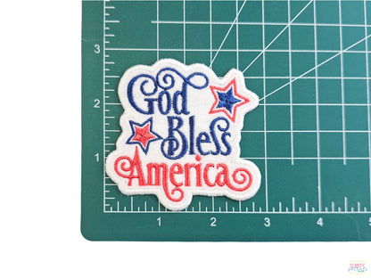 God Bless America patriotic embroidered patch with red, white, and blue stars, measuring approximately 3 inches wide.