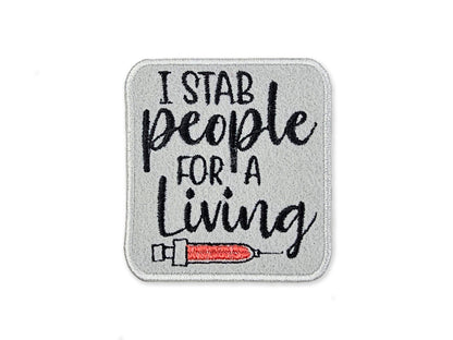 Embroidered patch with text 'I stab people for a living' and a syringe design on a gray background.