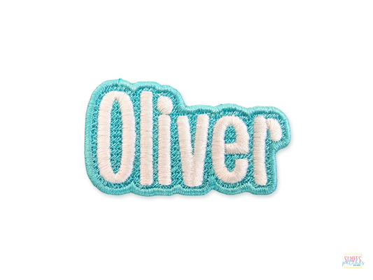 Oliver custom embroidered name patch with light aqua blue border and white script lettering on a white background | Shirts Patches And More