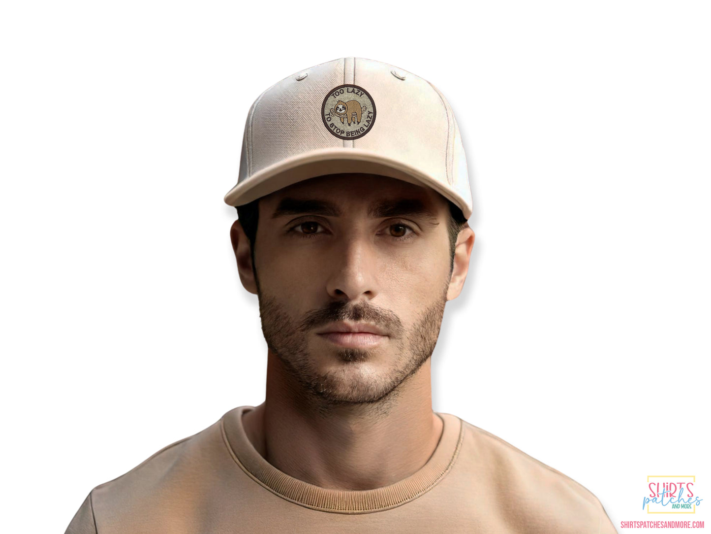 Lifestyle shot of a man wearing a beige baseball cap featuring the "Too Lazy to Stop Being Lazy" sloth patch, demonstrating the patch size and fit on headwear.