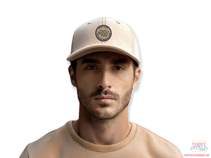 Lifestyle shot of a man wearing a beige baseball cap featuring the "Too Lazy to Stop Being Lazy" sloth patch, demonstrating the patch size and fit on headwear.