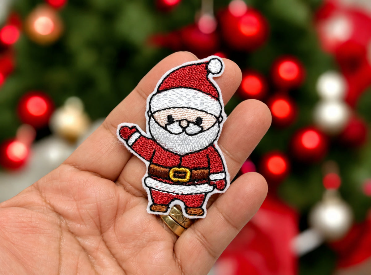 Waving Santa patch held in hand to show size - 1.81 by 2.50 inches