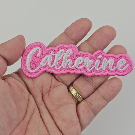 Video showing a close-up of the Catherine embroidered name patch held in hand and rotated to display stitching and details.