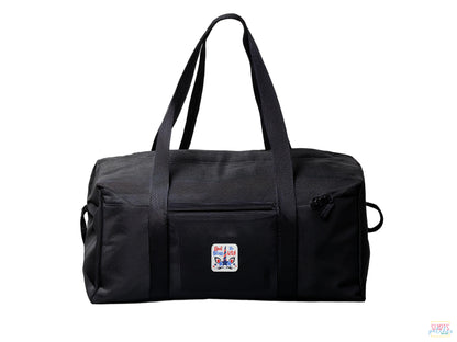 A black duffel bag on a white background featuring a small patriotic "God Bless The USA" unicorn embroidered patch on the front pocket.